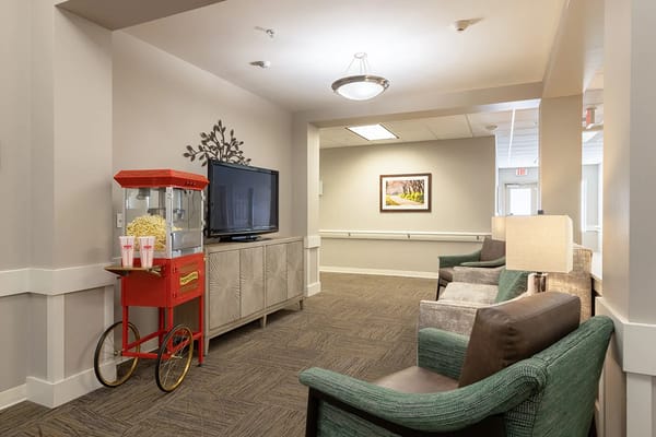 Interior common area with seating and a popcorn cart