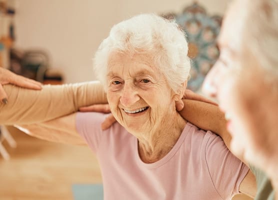 A smiling resident enjoying a group activity
