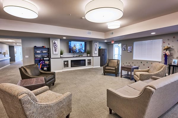 Bright common area with seating and a TV