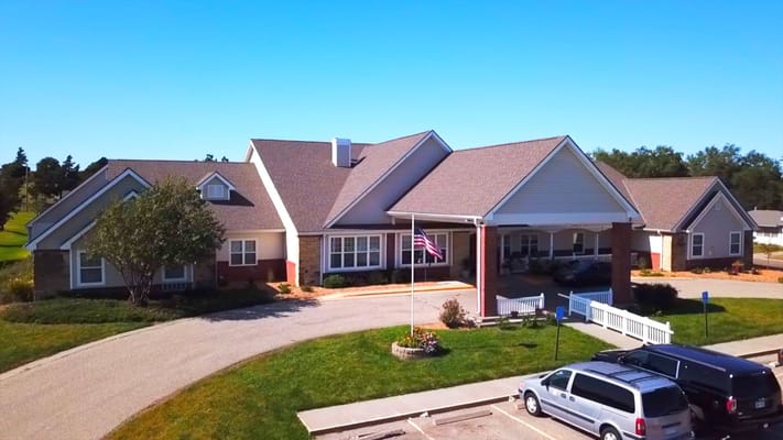 Exterior view of a senior living facility with landscaped grounds