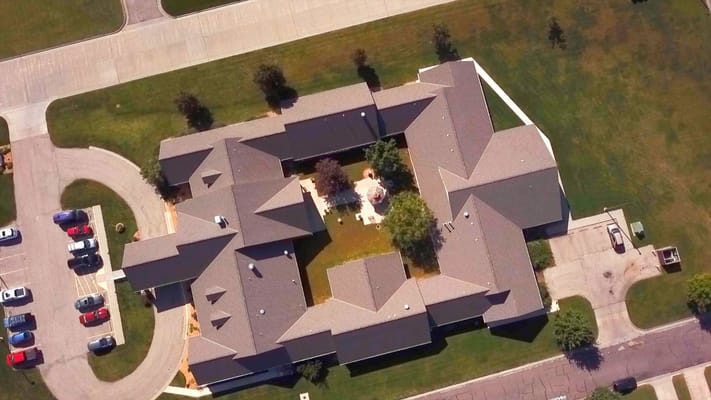 Aerial view of a senior living facility with landscaped grounds