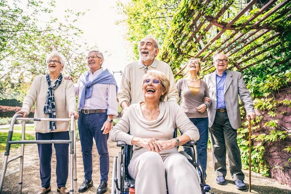 Group of smiling residents enjoying time outdoors