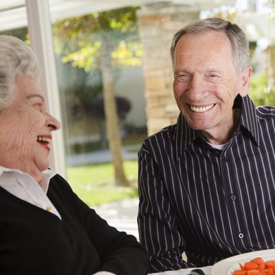 Residents enjoying a meal and laughing together