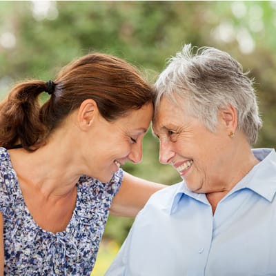 Two women smiling and connecting outdoors