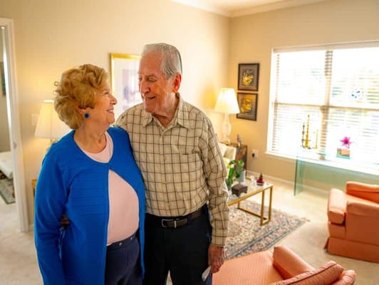 Couple smiling at each other in a cozy living room