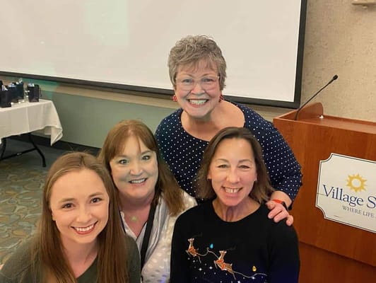 Staff members and residents smiling together at an event