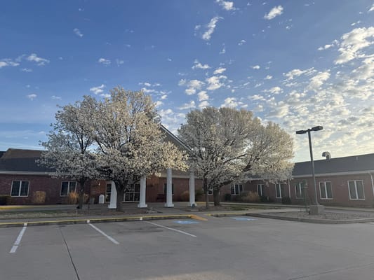 Exterior view of Lone Tree Retirement Community with blooming trees