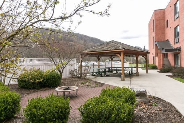 Outdoor gazebo area with seating and landscaping