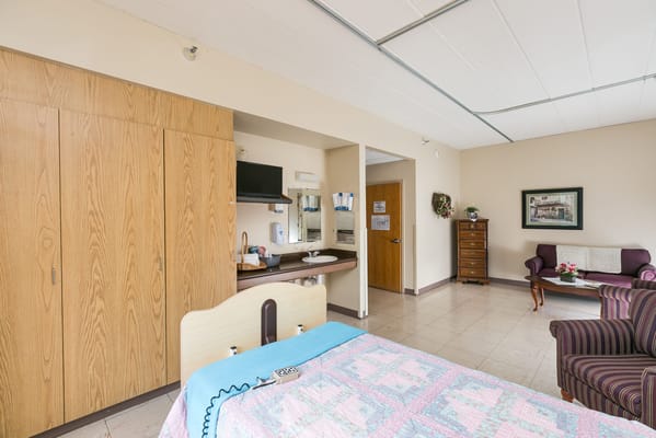 Bright and clean private resident room with furnishings