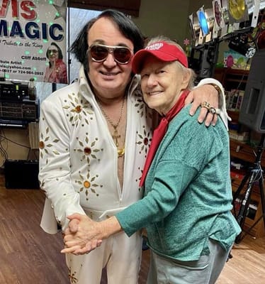 Resident dancing with Elvis tribute performer