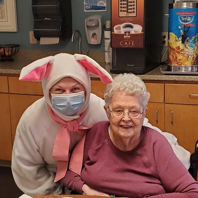 Staff in costume posing with a resident