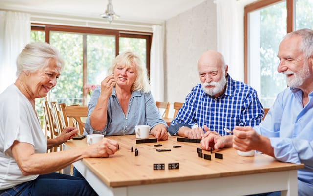 Residents playing a game together at a table