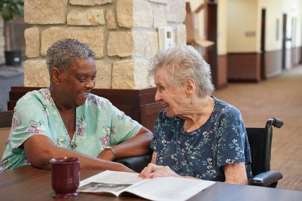 Two residents engaging happily in a common area