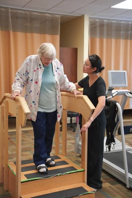 A therapist assisting a resident during rehabilitation