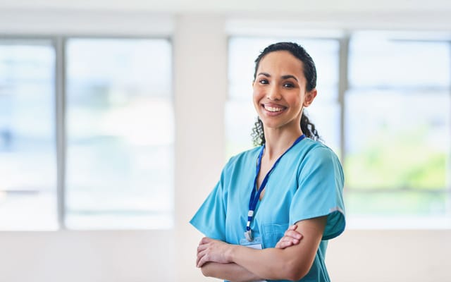 Smiling healthcare worker in a bright facility interior