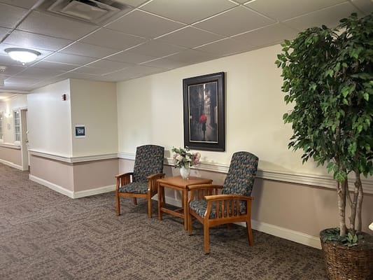 Seating area in a hallway with floral decoration