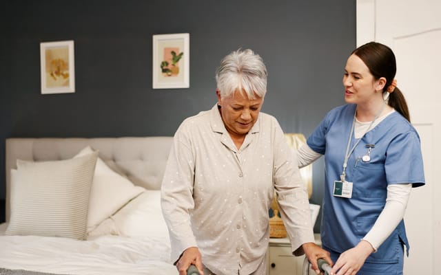 A staff member assisting a resident in a room