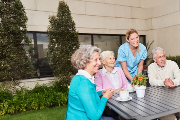 Residents enjoying time outdoors with staff