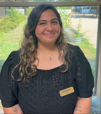 Staff member posing in a well-lit interior space