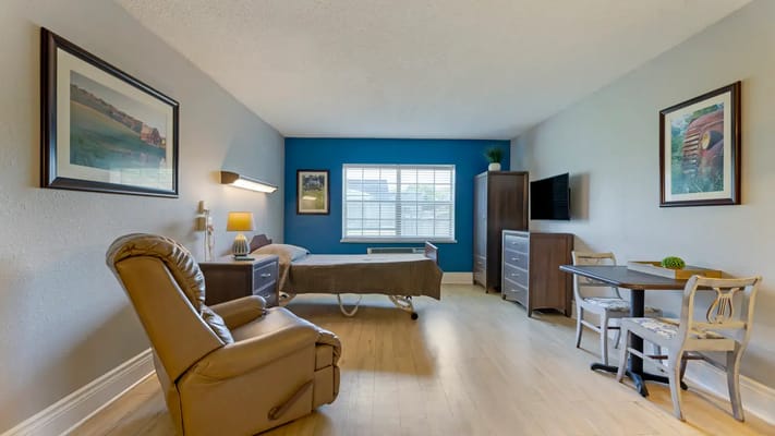 A cozy resident room with a view and furnishings