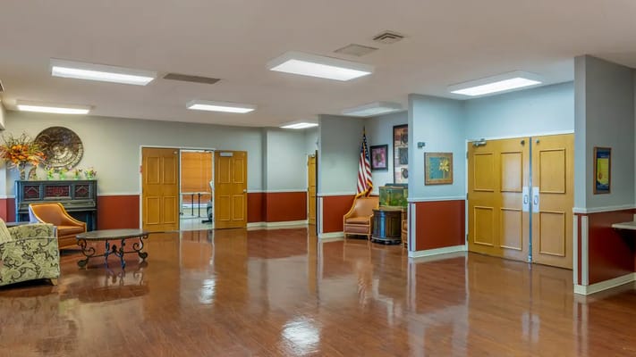 Bright and spacious common area with chairs and decor
