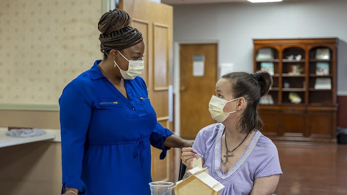 Staff interacting with a resident in a care facility
