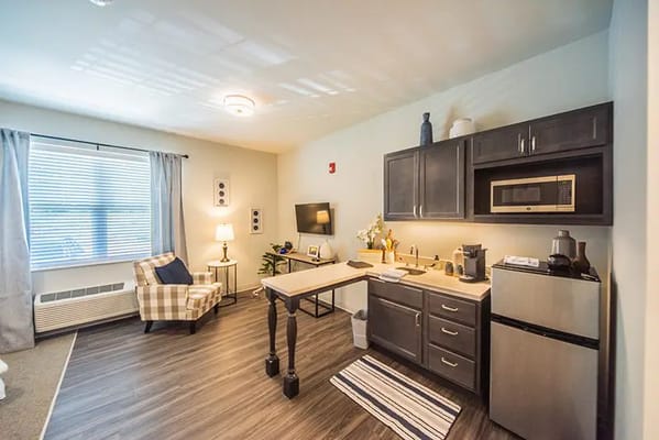Cozy resident room with a kitchenette and seating area