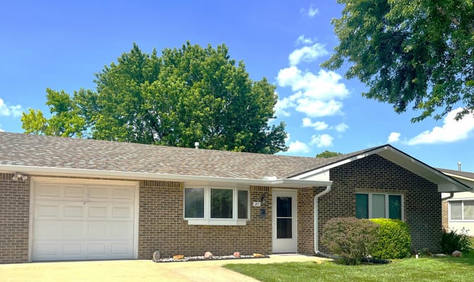 Exterior view of a residential building with a yard