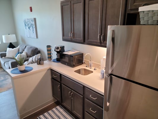 Cozy interior of a resident's room with kitchen area