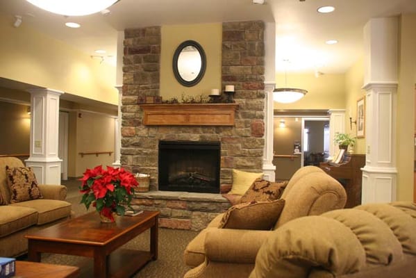 Interior common area with a cozy fireplace and seating