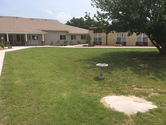 Outdoor space with grass and garden features