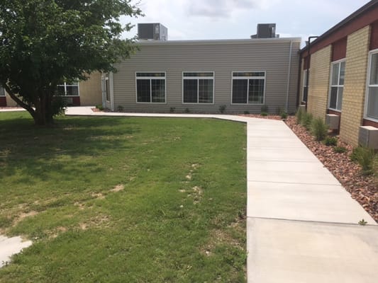 Exterior view of the retirement center with pathway and landscaping