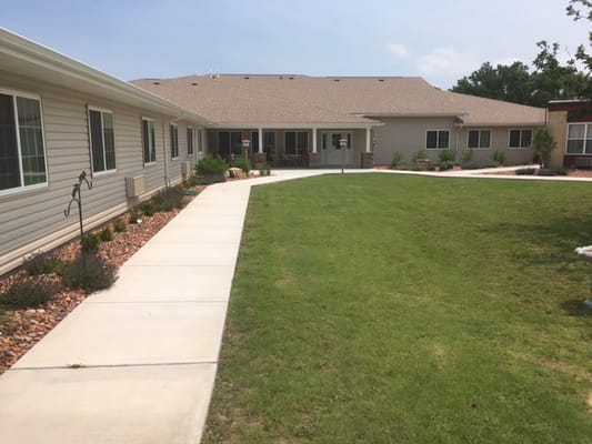 Pathway through landscaped outdoor area of a retirement facility