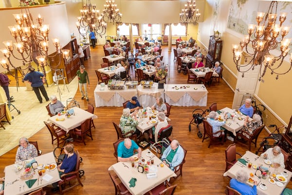 Dining area with residents enjoying meals and conversation