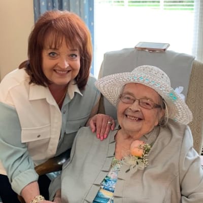 Resident enjoying time with staff member in interior