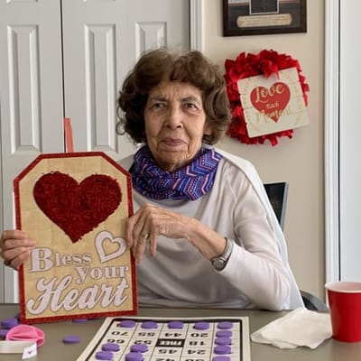 Resident playing bingo with heart decorations
