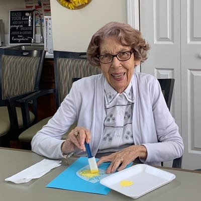 A resident engaged in an arts and crafts activity