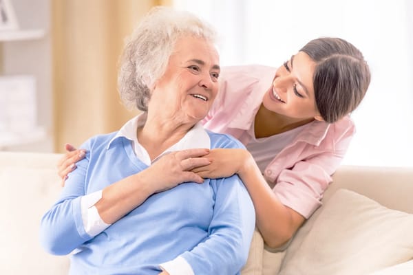 Caregiver interacting with a resident in a cozy living area