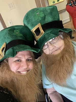 Resident and staff wearing St. Patrick's Day hats