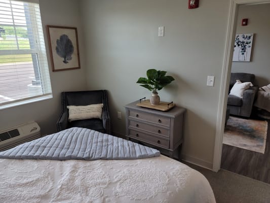 Cozy resident room with a chair and plant