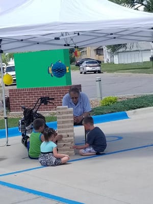 Residents and a staff member playing a game outdoors