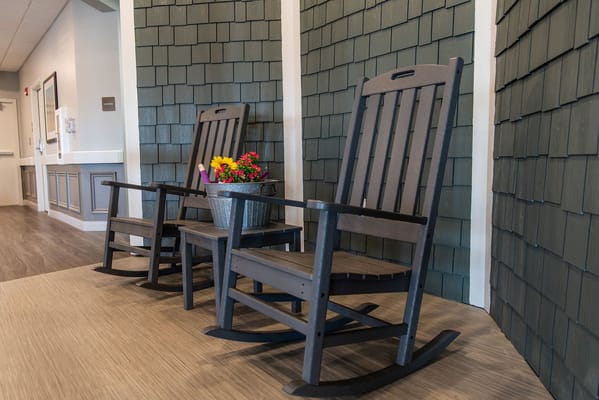 Rocking chairs with flowers in a welcoming hallway