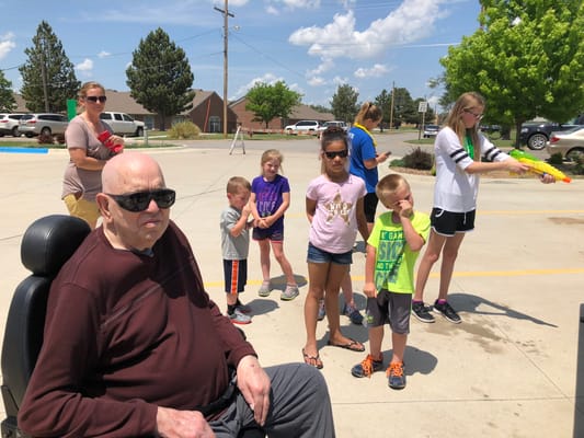 Residents and staff enjoying water activities outside