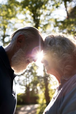 Couple enjoying a moment outdoors with sunlight