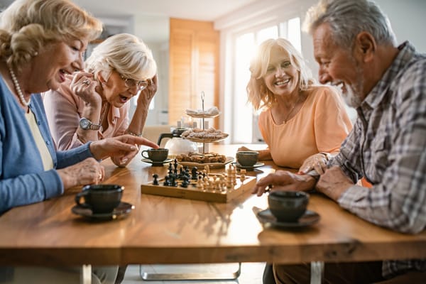 Seniors enjoying a game of chess in a common area