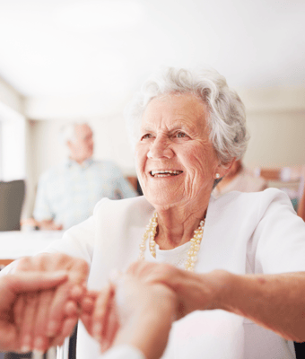 Senior resident smiling in a common area