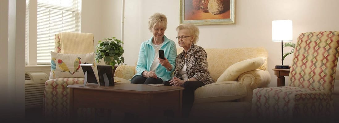 Staff member assisting a resident in a comfortable living space