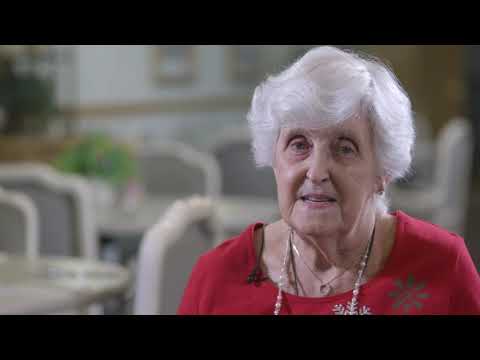 A resident in a vibrant red shirt smiling
