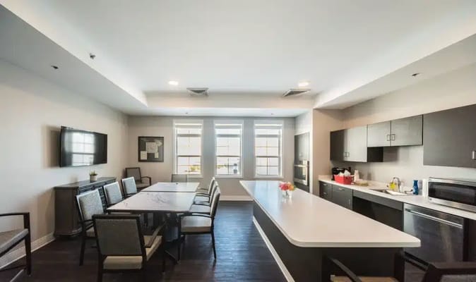 Bright common area with dining and kitchen facilities