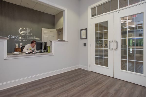 Reception area of Cardinal Landing Memory Care with staff member